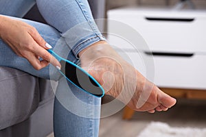 Woman Filling Foot With Foot File photo