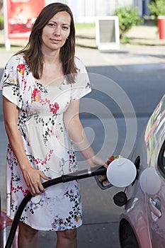 Woman filling gasoline inside the car