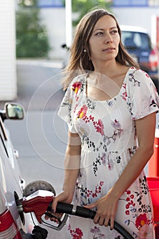 Woman filling gasoline inside the car
