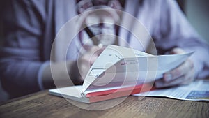 Woman filling a HSBC cheque book with fountain pen