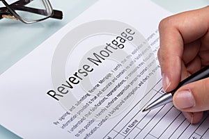 Woman Filling Reverse Mortgage Form photo