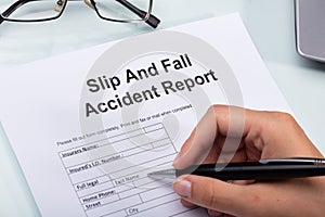 Woman Filling Slip And Fall Accident Report photo