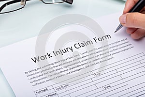 Woman Filling Work Injury Claim Form