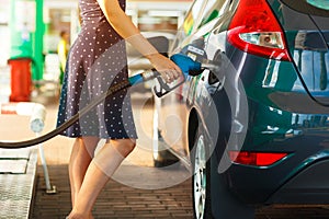 Woman fills petrol into her car