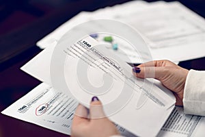 Woman fills the tax form, working with tax documents. Form 1040 Individual Income Tax return form. United States Tax forms.