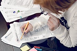 Woman fills the tax form, working with tax documents. Form 1040 Individual Income Tax return form. United States Tax forms.