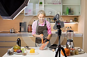 Woman filming cooking vlog. Concept of vlogging, blogging and content creation photo