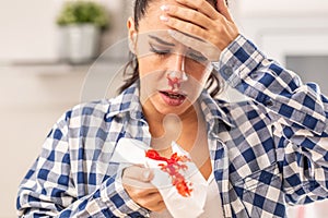 Woman find out her nose is bleeding after sneezing into a tissue