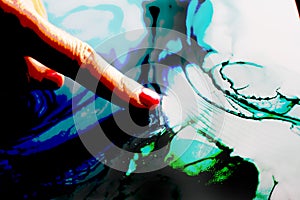Woman finger indicating an abstract color background photo