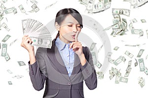 Woman finger on lips asking quiet with money