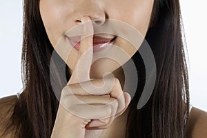 Woman with finger on lips. Conceptual image