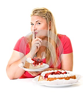 Woman with finger to lips and cream cakes