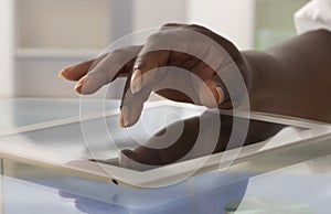 Woman finger touching a tablet's touchscreen