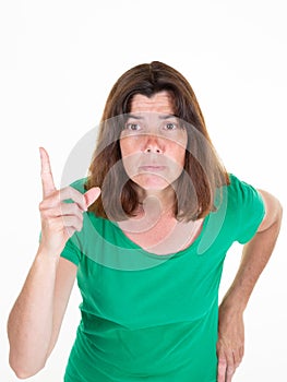 Woman with finger up and angry Head shot Portrait middle aged female in green shirt over white background