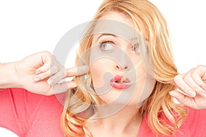 Woman with fingers in ears