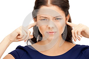 Woman with fingers in ears