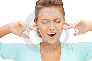 Woman with fingers in ears