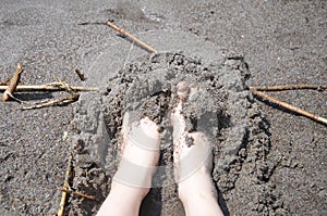 Woman fingers in the grit at the beach