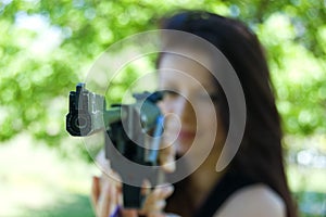 Woman firing with pneumatic gun