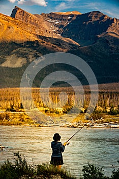 A woman fishing in Alberta\'s North Saskatchewan River, Canada