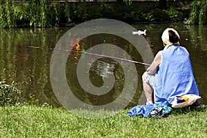 Woman fishing in a city park