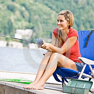 Woman fishing on pier