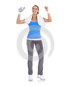 Woman, fist and water bottle for fitness in studio with exercise, workout success or body goals and achievement