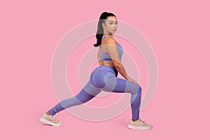 Woman in fitness clothing performing a lunge