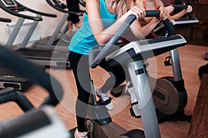 Woman on fitness exercise bike at indoor