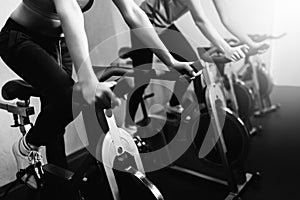 Woman on fitness exercise bike at indoor