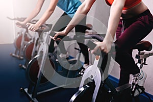 Woman on fitness exercise bike at indoor