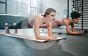Woman, fitness and full body in plank for core workout, exercise or training together at the gym. Women doing intense ab