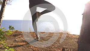 Woman fitness runner on top happy and celebrating success. the woman enjoys the view of the sea from the mountain, she