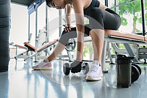 Woman fitness training an exercise class in the gym. Weight lifting or holding dumbbells for beginners. Fitness exercise building