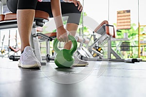 Woman fitness training an exercise class in the gym. Weight lifting or holding dumbbells for beginners. Fitness exercise building