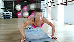 Woman fitness workout wellness concept. Athlete girl does exercises on the gym