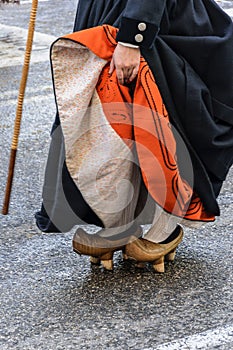 A woman fits motheries, rustic wooden shoes that were used in Cantabria Spain