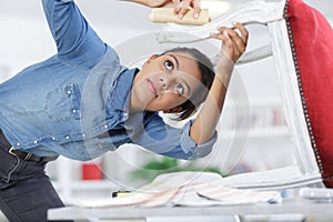 woman fixing chair with staple