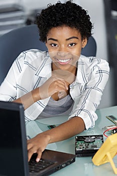 Woman fixing computer indoors