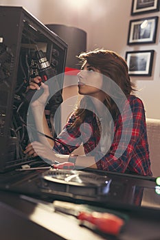 Woman fixing a computer