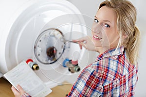 Woman fixing heating system with special tool