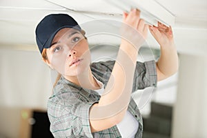 Woman fixing light