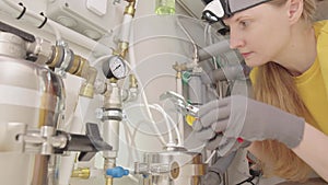 A woman fixing plumbing in the kitchen