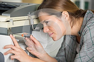 woman fixing printer
