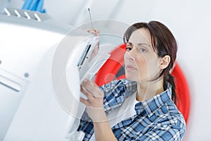 Woman fixing printer at office