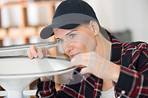 woman fixing rubber seal to base chair