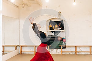 woman flamenco dancer moving arms in a dance studio