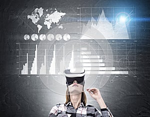 Woman in flannel shirt and vr glasses and graphs
