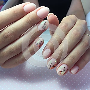 Woman with flesh-colored manicure with design, close up