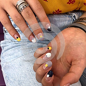 Woman with flesh-colored manicure with design, close up